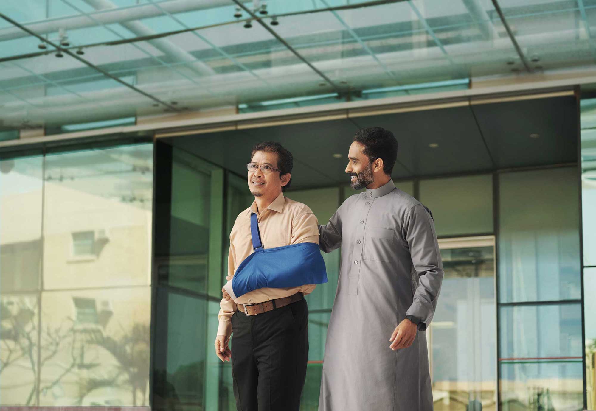 Man supporting adult with arm sling, representing Bupa Helpers health insurance" unoptimized
